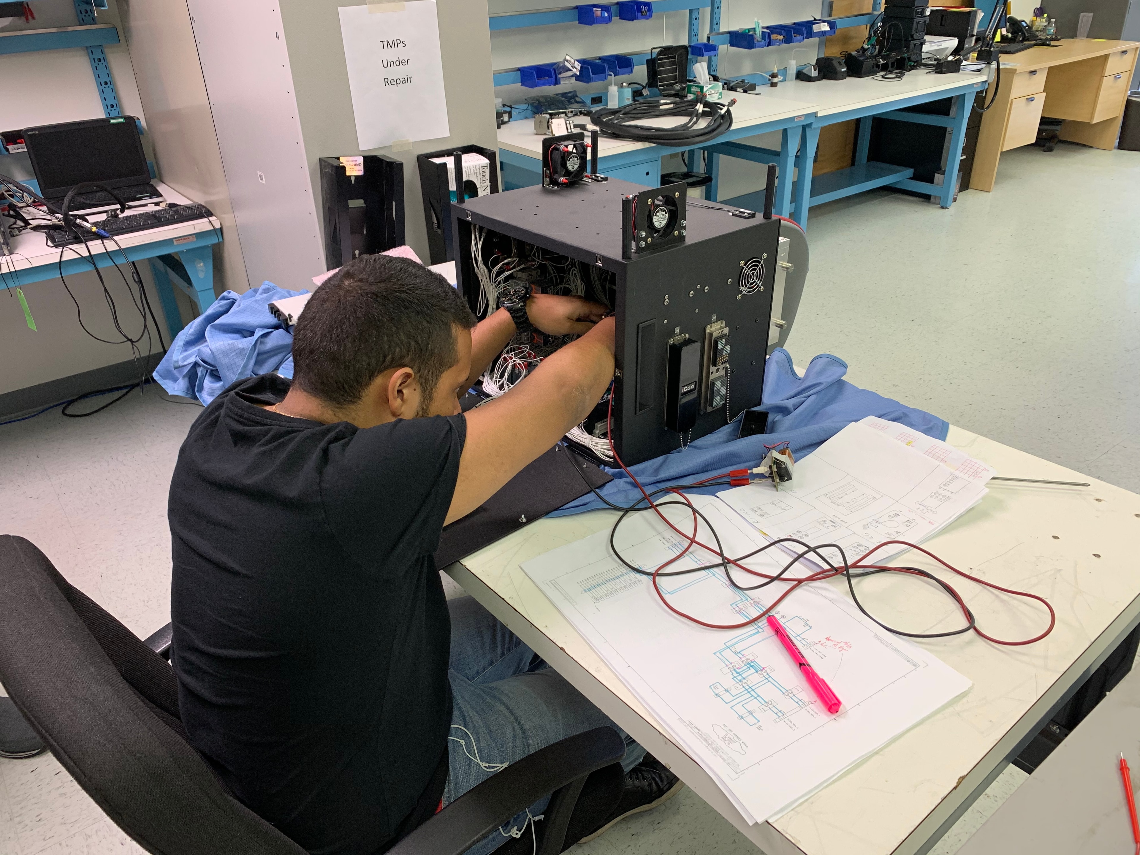 JIRACOR technician performing electronics integration and repair work at the Orlando facility