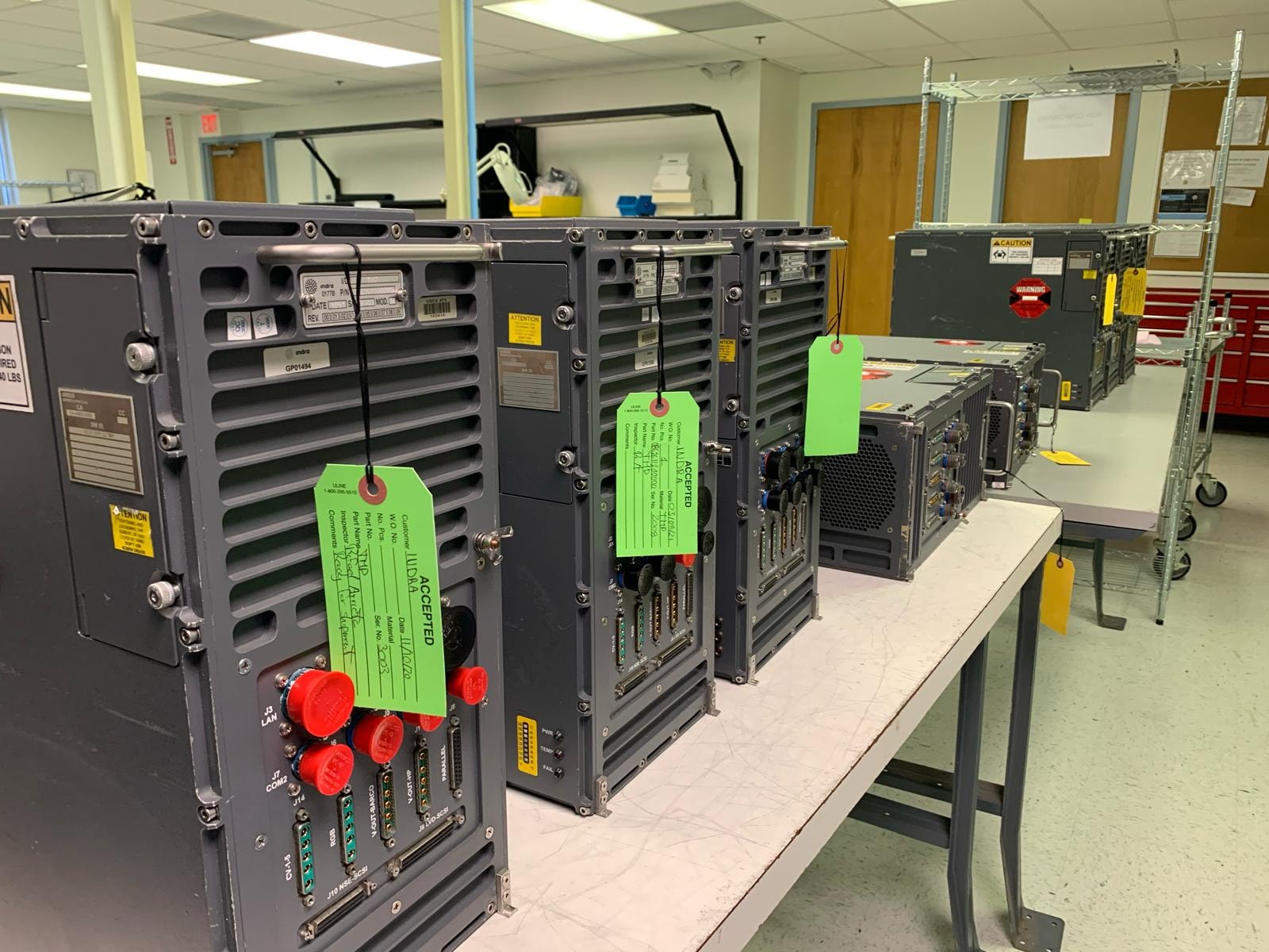 JIRACOR Orlando facility — accepted equipment units with green inspection tags staged on work tables
