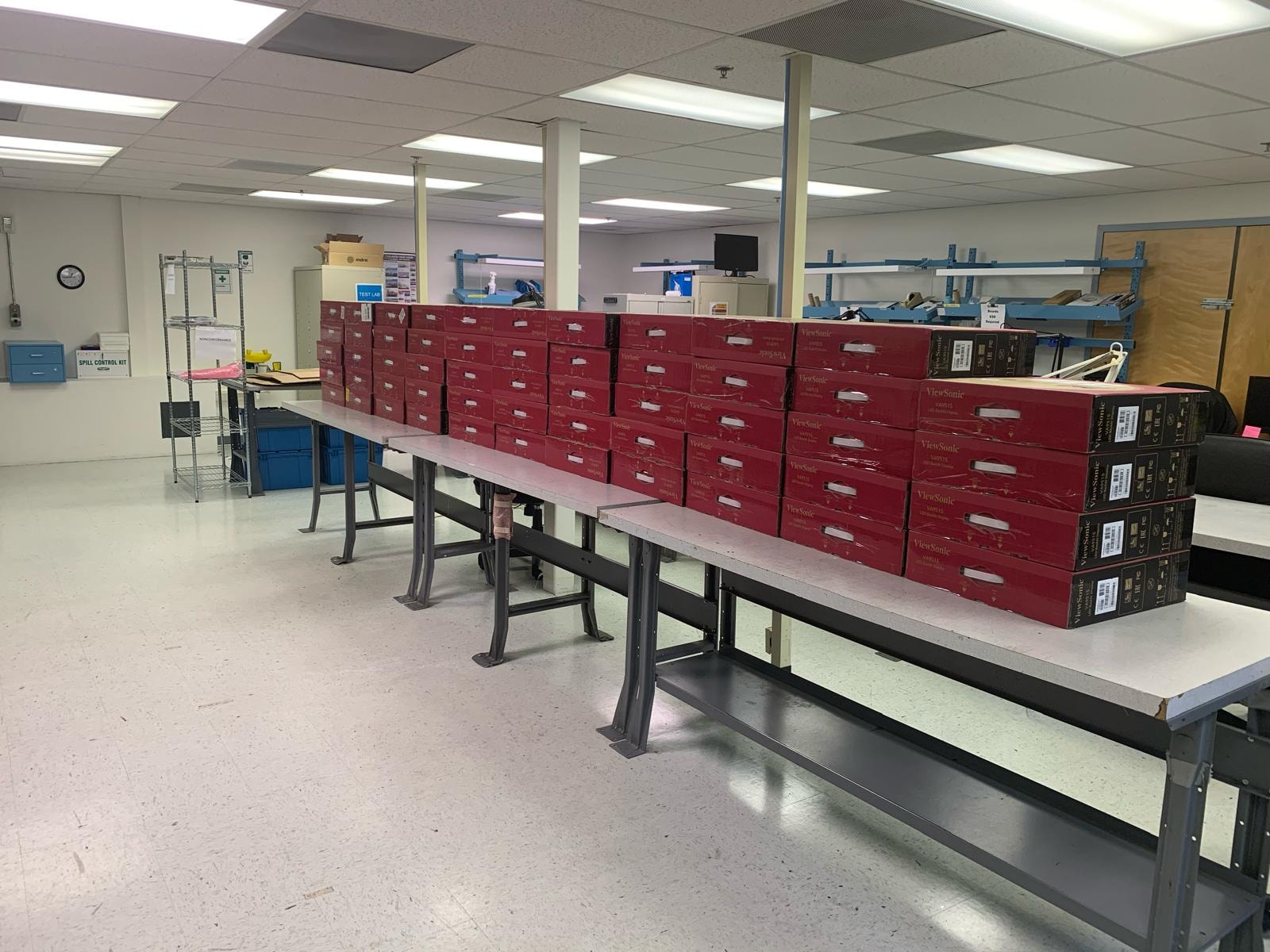 JIRACOR Orlando facility — boxed equipment staged on work tables in the warehouse and logistics area