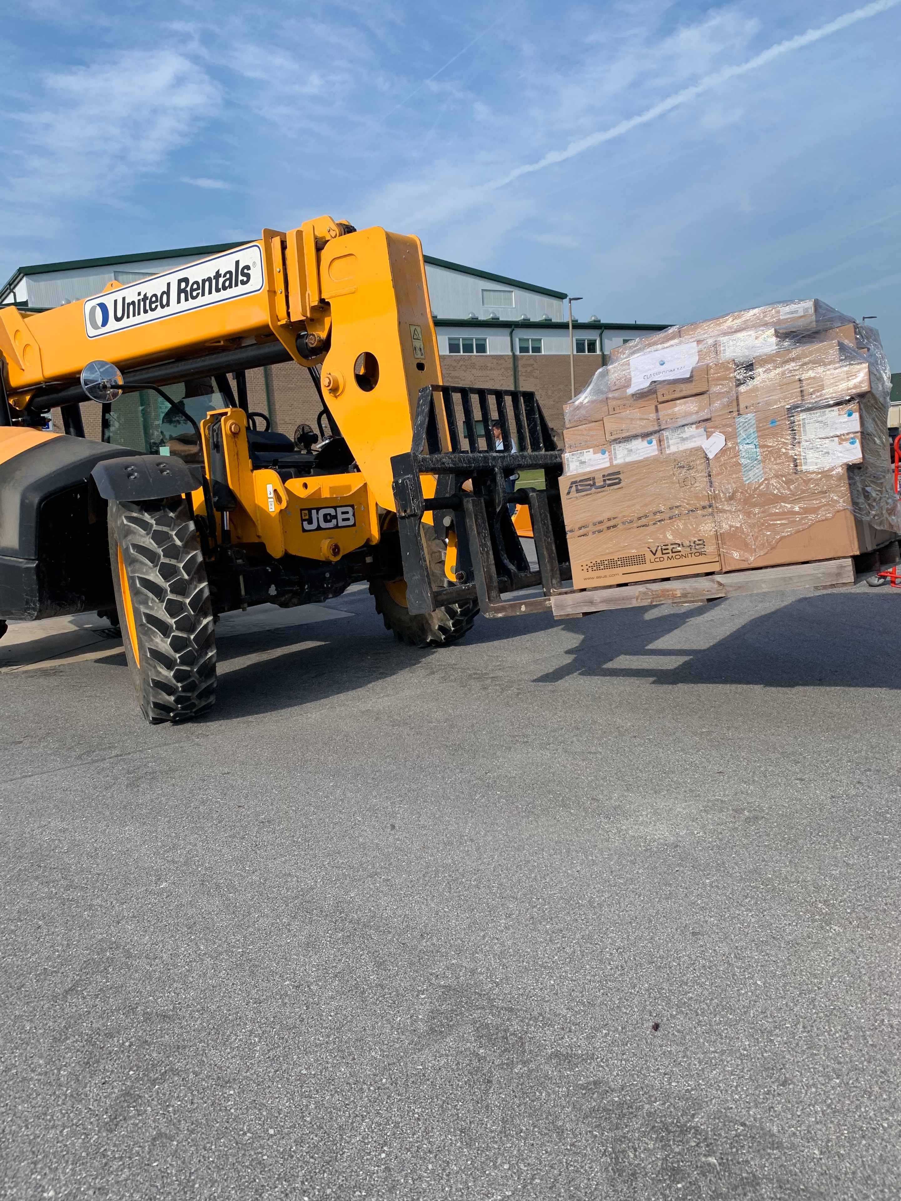 Palletized IT and technical equipment being moved at the JIRACOR facility for customer deployment