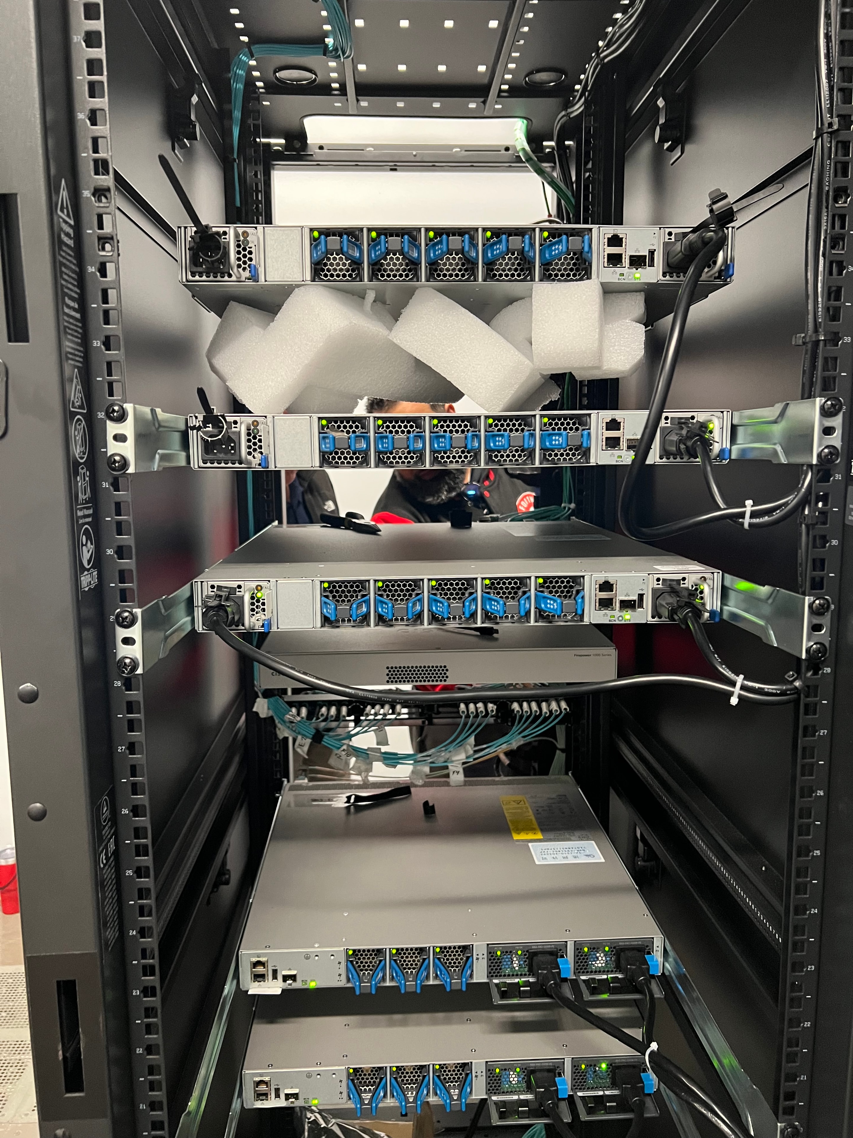 JIRACOR hardware integration — blade modules and fiber optic transceivers installed in equipment rack