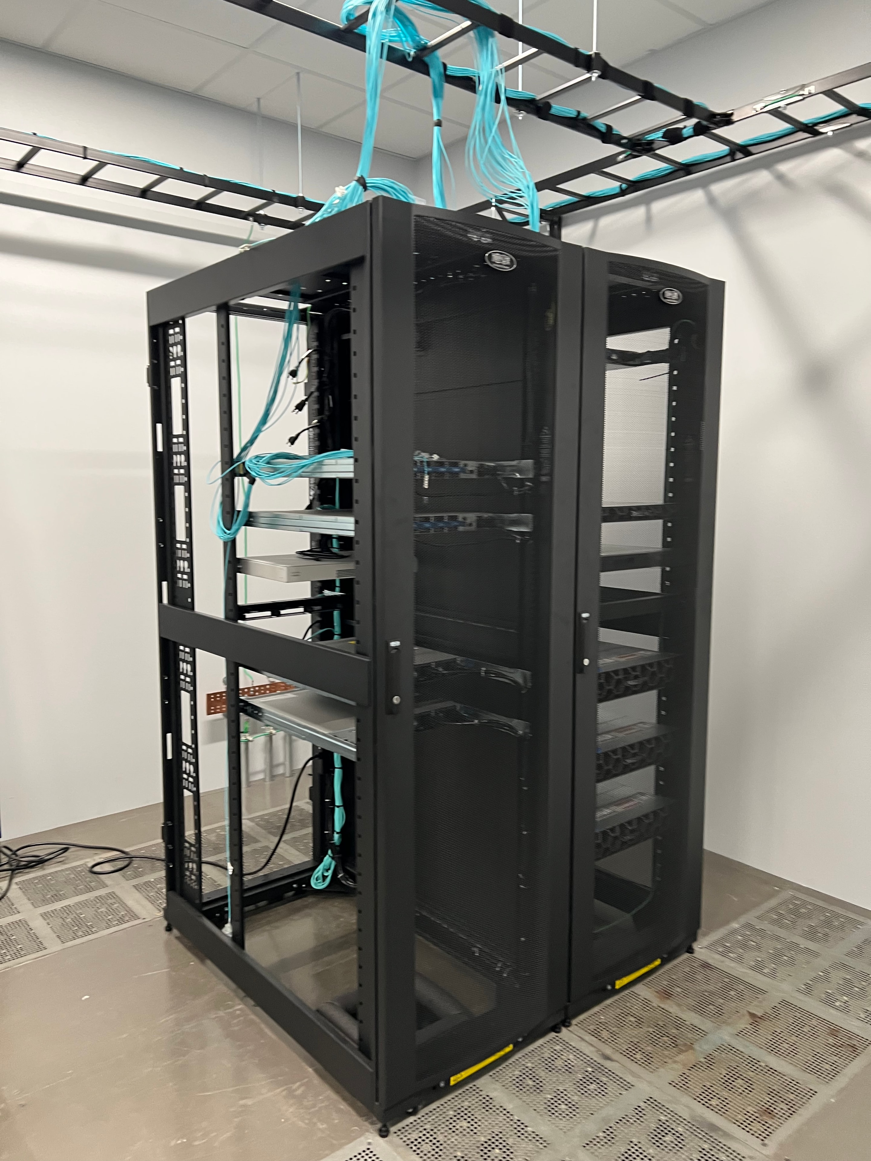 Completed equipment racks with structured fiber optic cabling supporting modernized training system infrastructure installed by JIRACOR