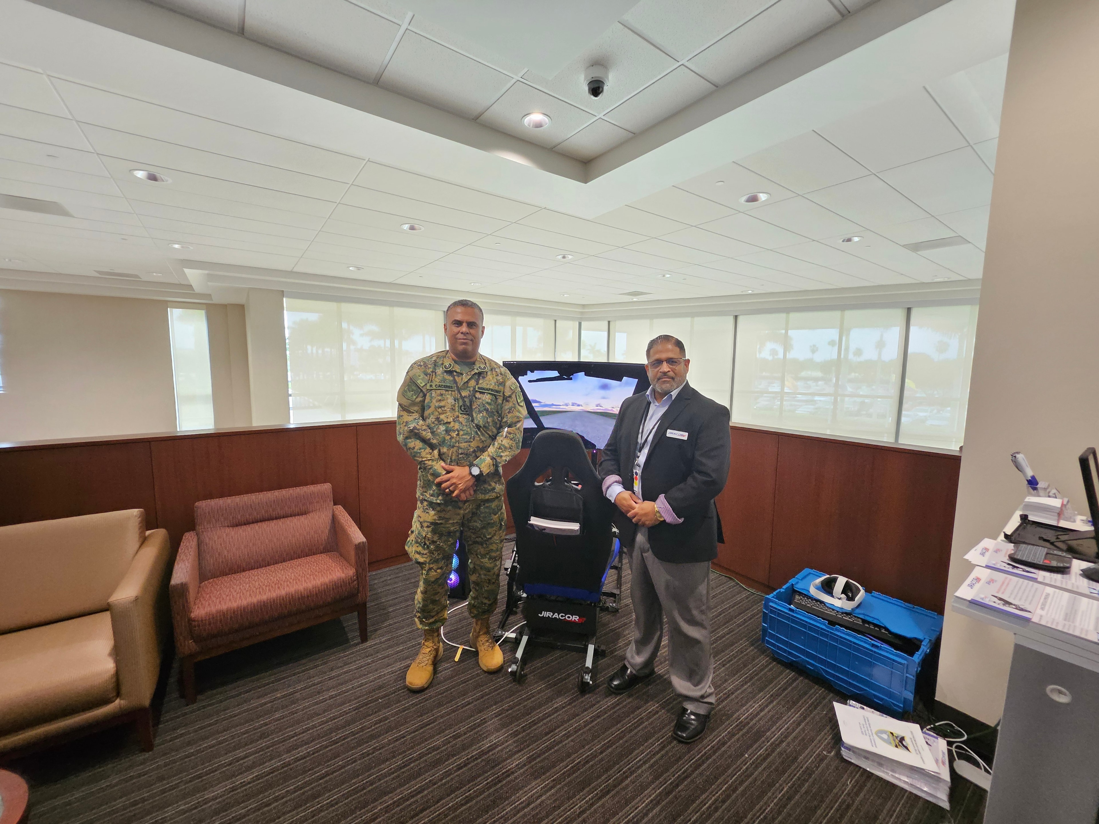 JIRACOR representative with military officer at the JIRASIM™ simulator demonstration