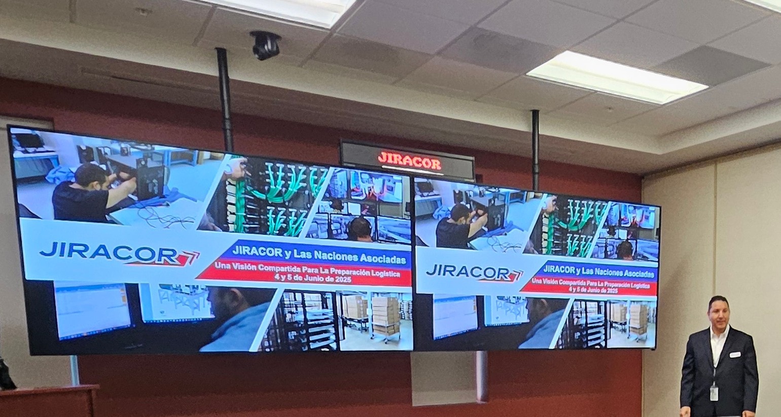 JIRACOR capabilities presentation displayed on large screens in a briefing room.