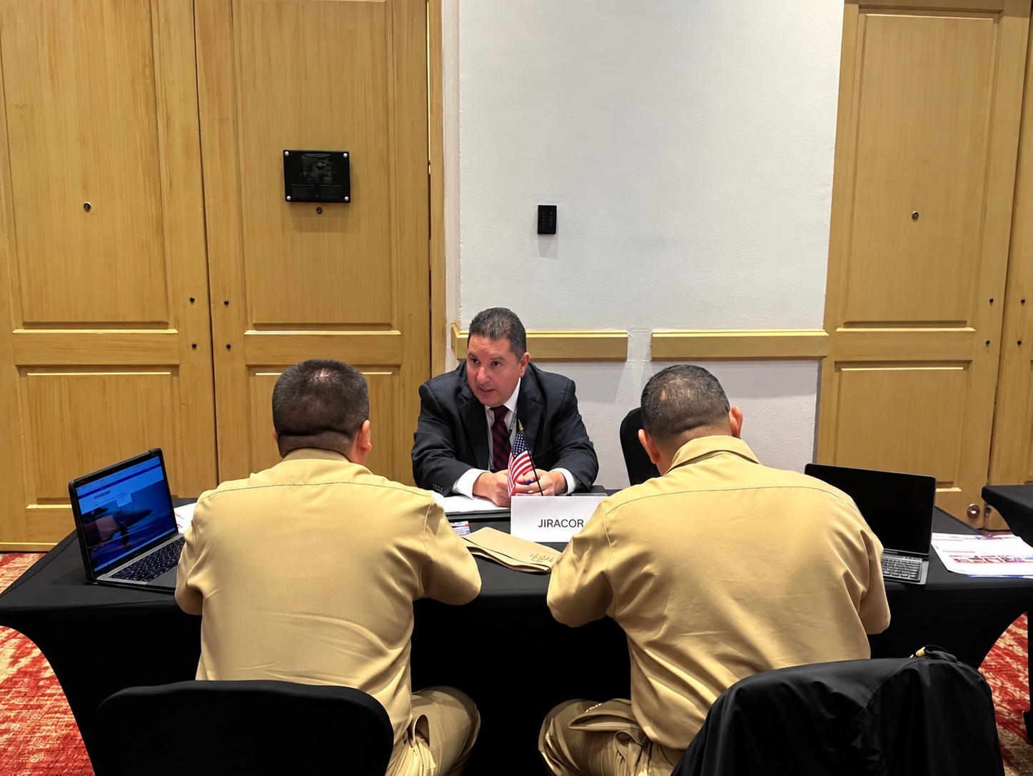 JIRACOR representative meeting with military personnel during a professional engagement.